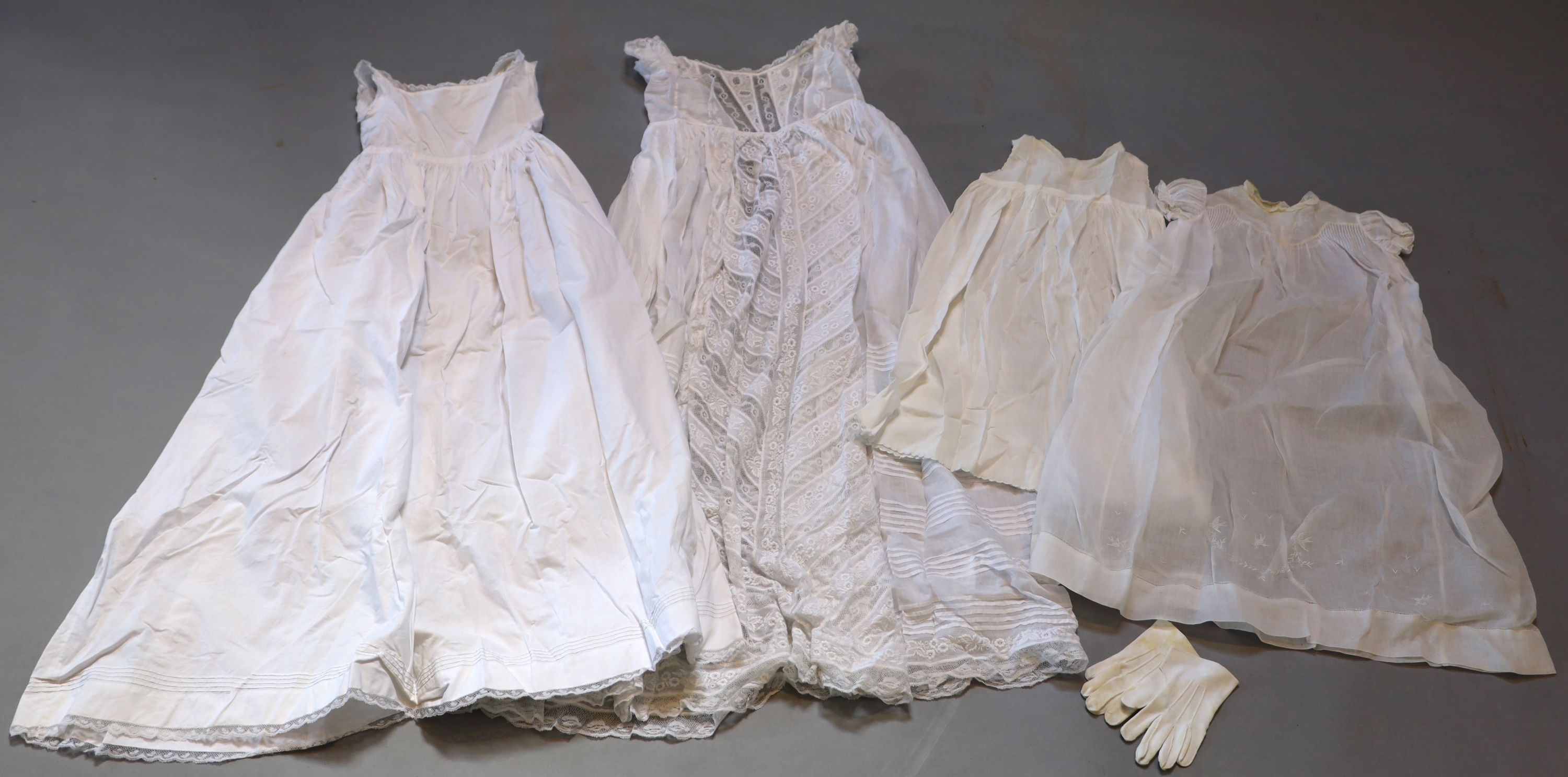 A collection of embroidered whitework christening robes